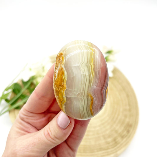 Pink banded calcite palm stone